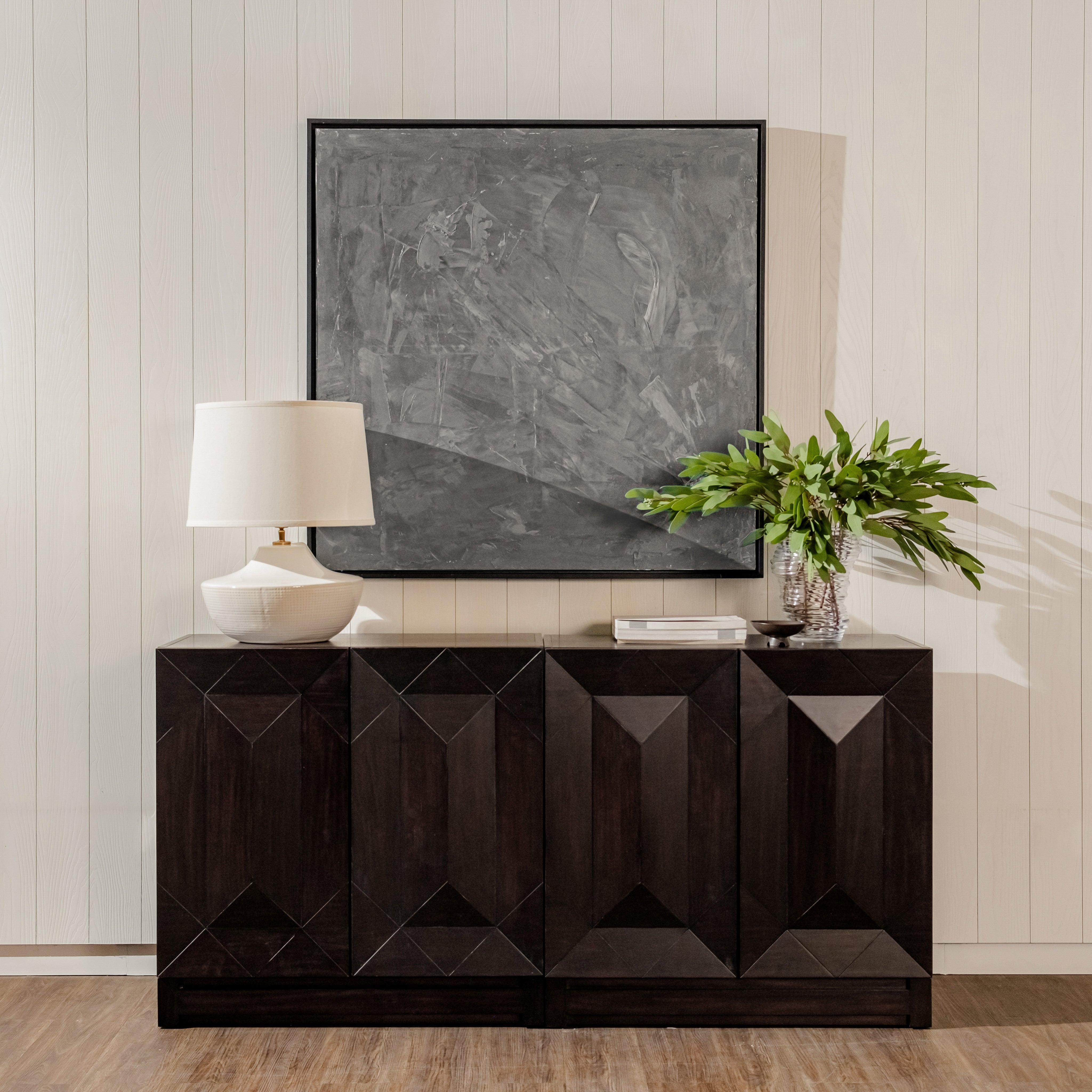 Black Averi Modular Cabinet with decorative items against a light wall.