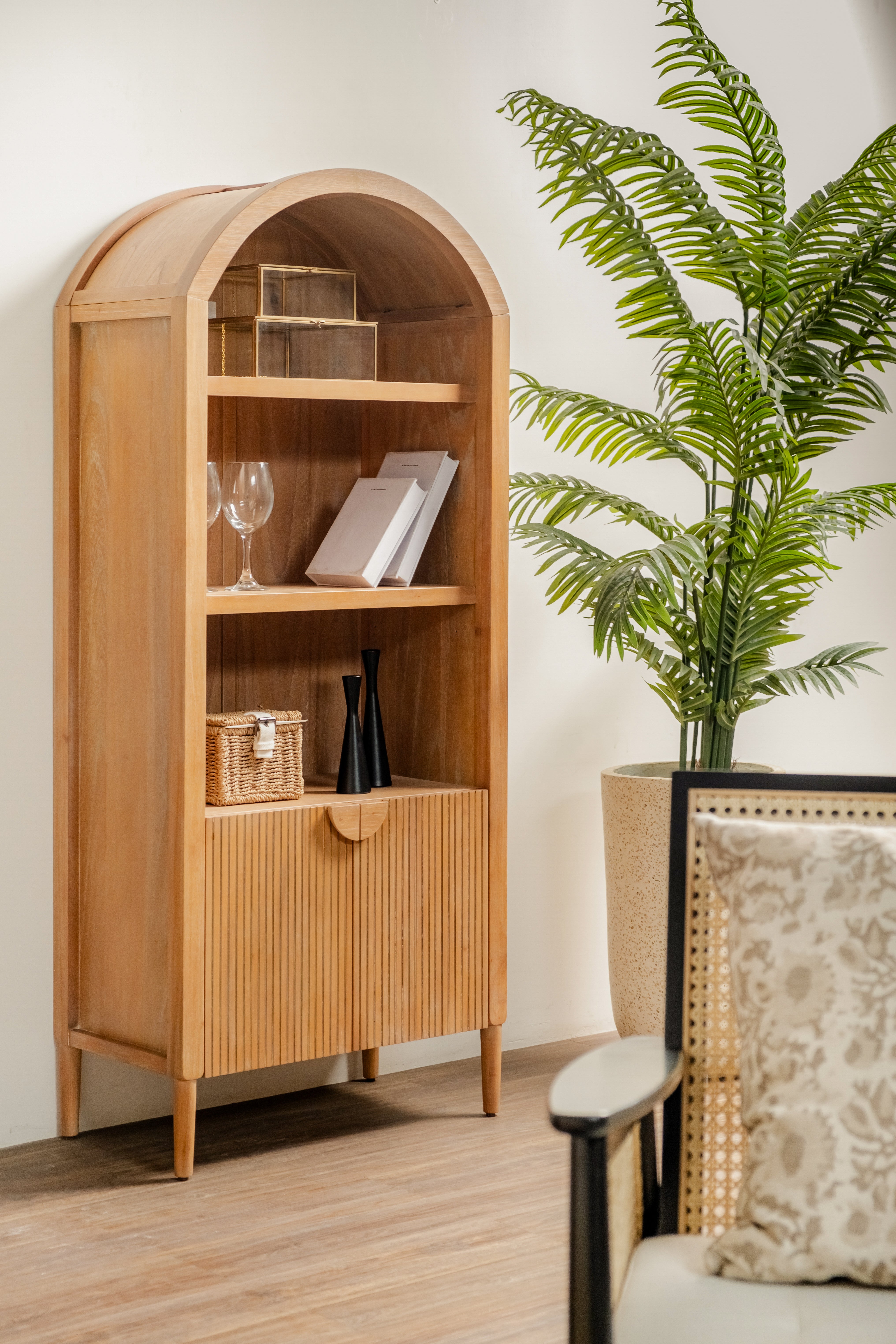 Javon Natural with decorative items in a room with a plant and chair.