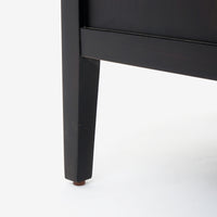 Black wooden leg of a piece of Black Kalana - 2-Drawer Rattan Nightstand