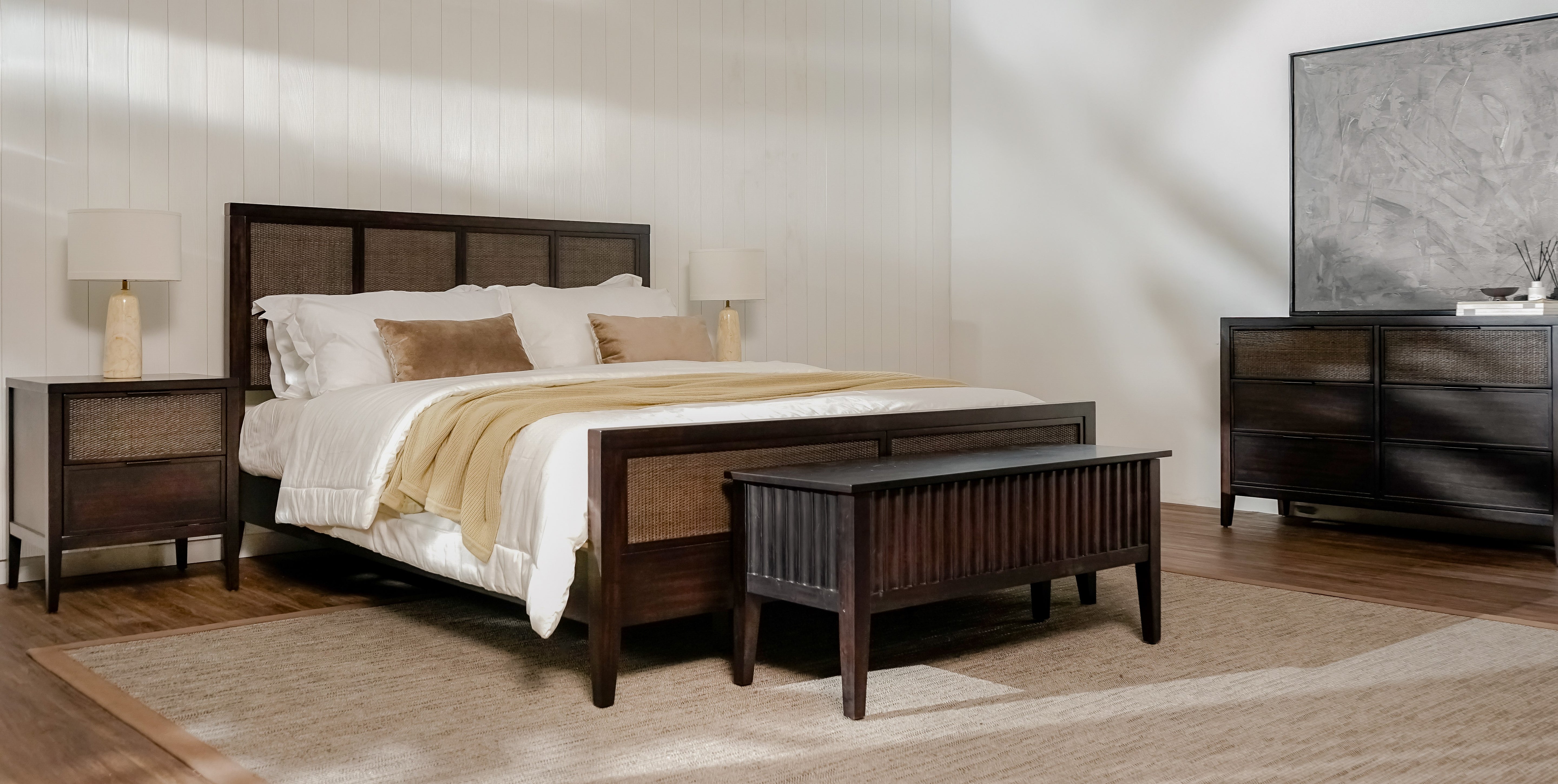 Bedroom with wooden bed, Black Kalana 6 Drawer Rattan Dresser , and dresser.