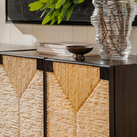 Cabinet with wicker doors and decorative items on a shelf