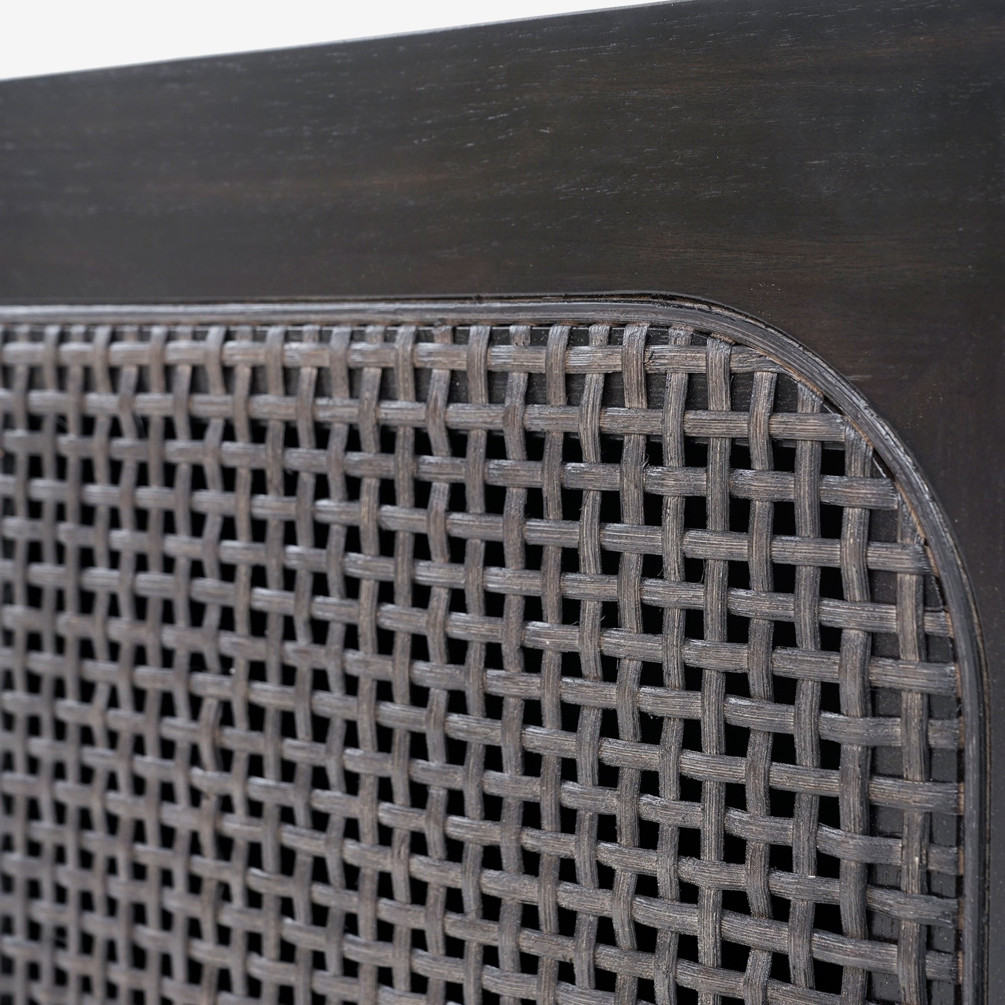 Close-up of a woven metal grill on a wooden surface