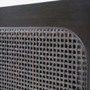 Close-up of a woven metal grill on a wooden surface