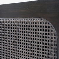 Close-up of a woven metal grill on a wooden surface