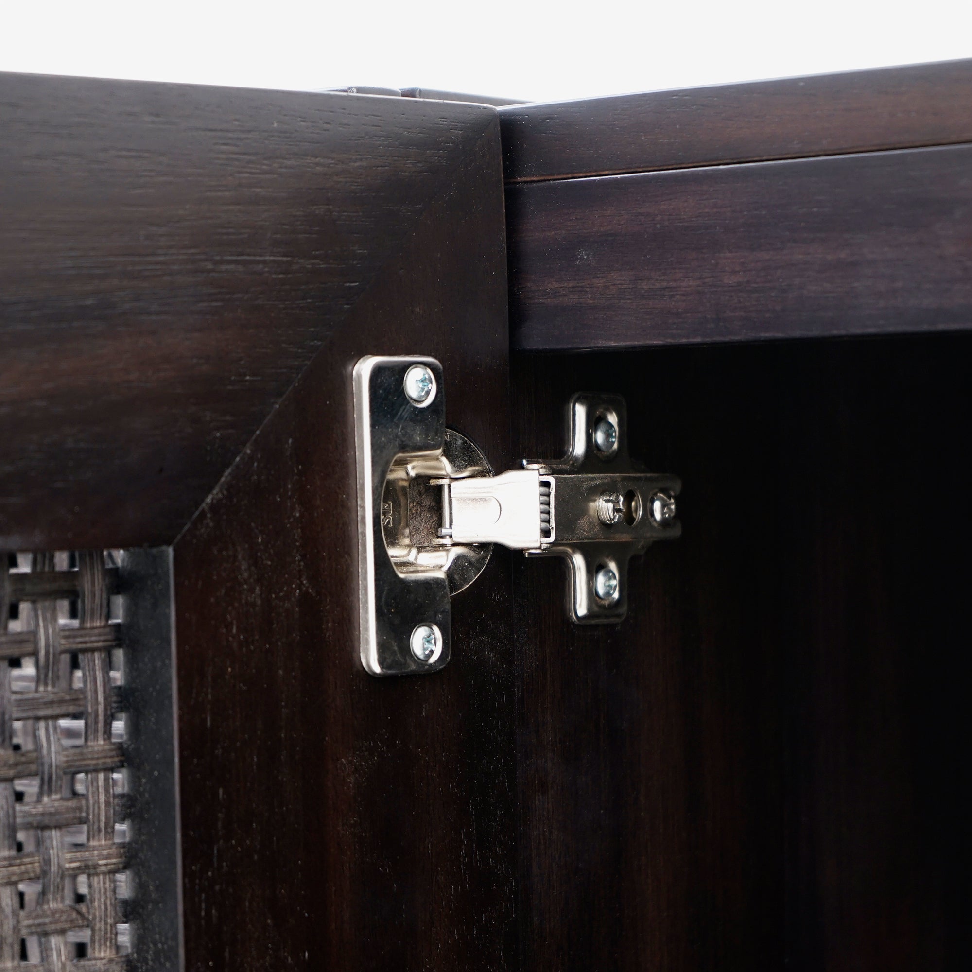 Close-up of a wooden cabinet with a hinge
