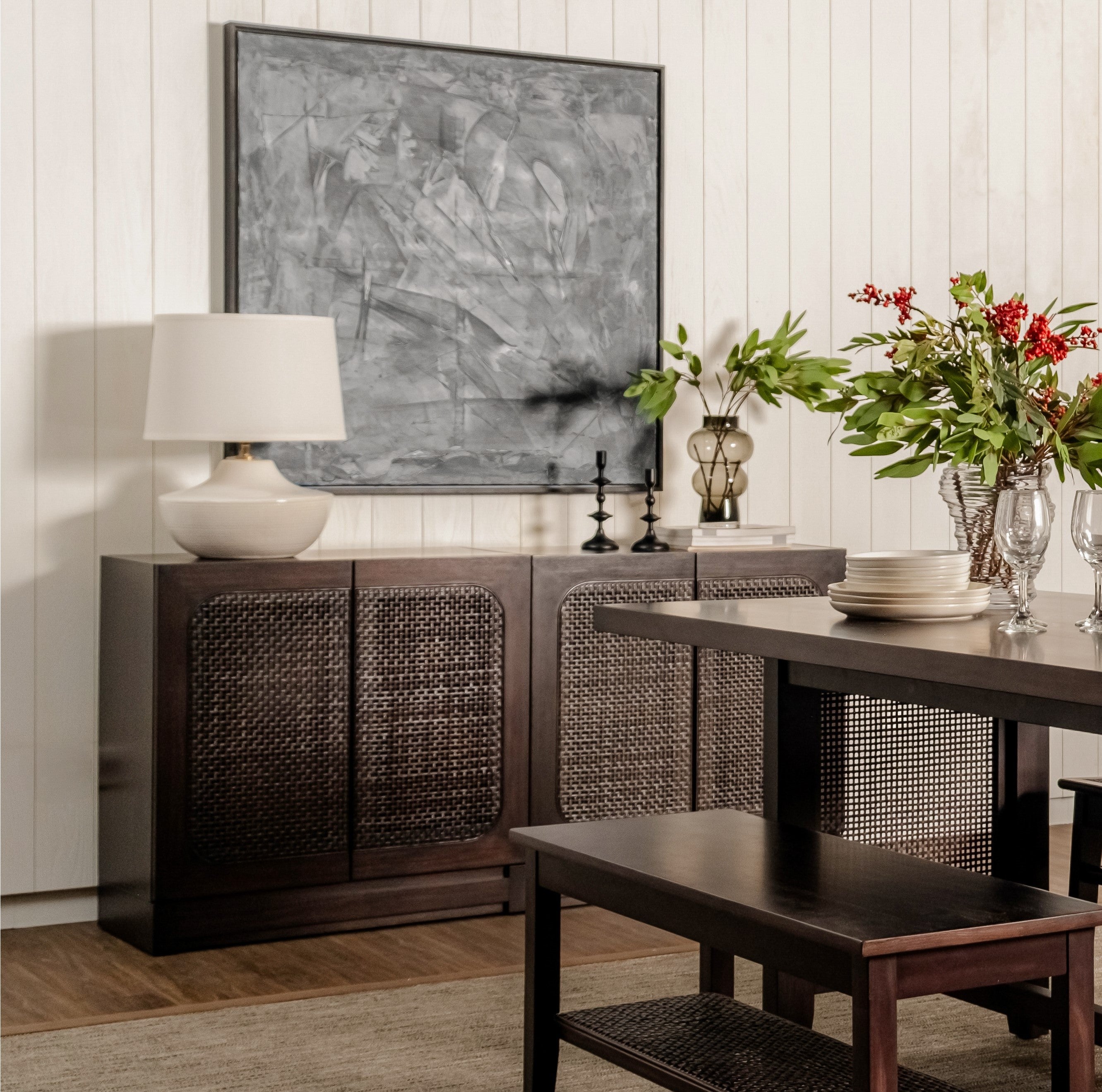 Dining room with dark wood sideboard, table, and decorative elements.