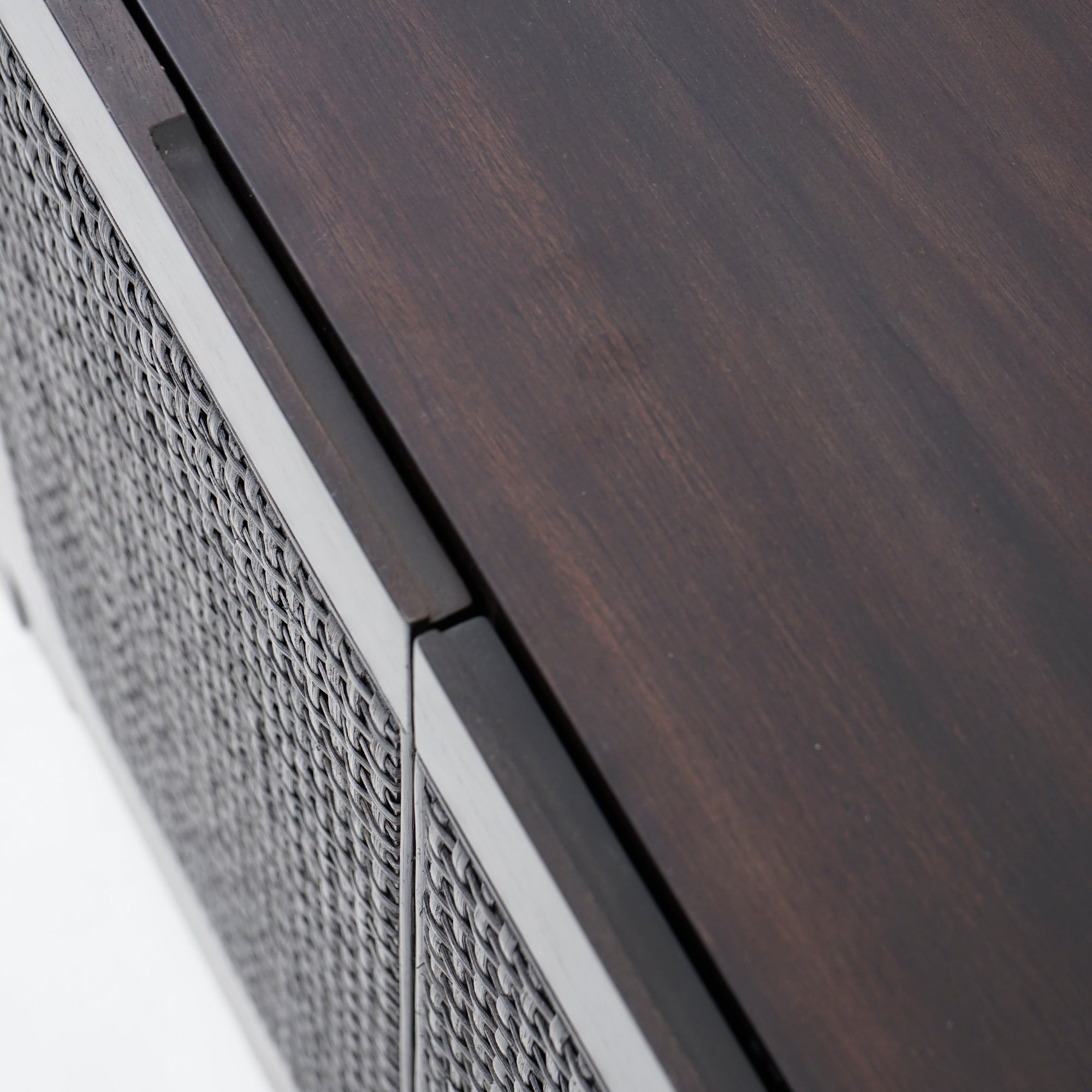 Close-up of a wooden surface with a textured metal panel