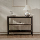 Wooden console table with decorative items against a neutral wall.
