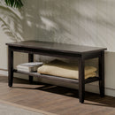 Dark wooden bench with a shelf against a light-colored wall.