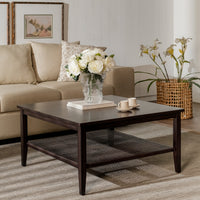 Living room with a dark wooden coffee table, beige sofa, and decorative elements.