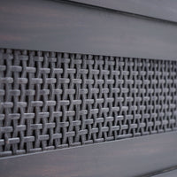Close-up of a textured metal surface with a grid pattern
