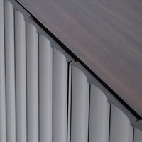 Close-up of a roofline with wooden shingles and metal flashing.