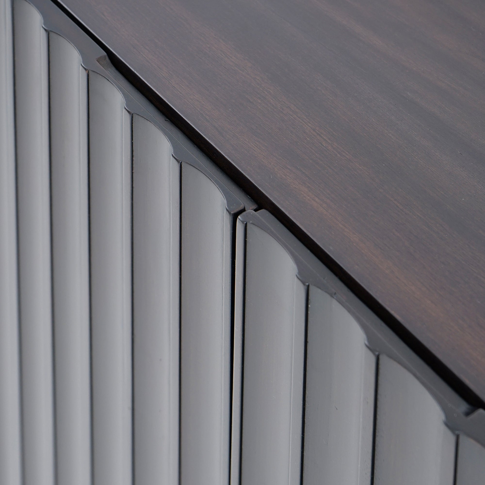 Close-up of a roofline with wooden shingles and metal flashing.