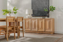 Natural Averi Modular Cabinet with chairs and a sideboard in a room with plants and a television.