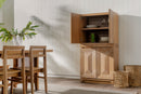 Natural Averi Modular Cabinet in a room with light-colored walls and wooden floor.