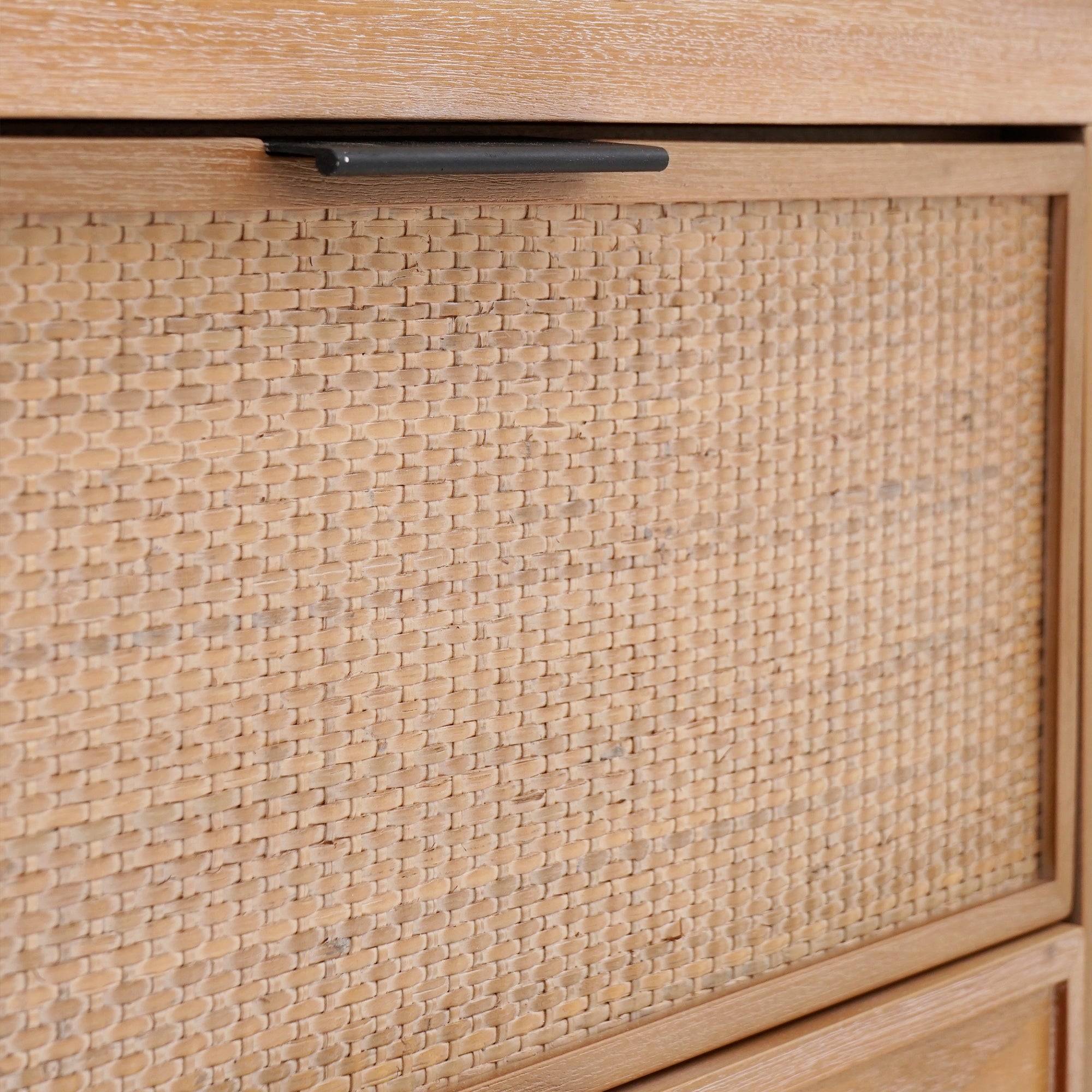 Close-up of a wooden drawer with woven texture