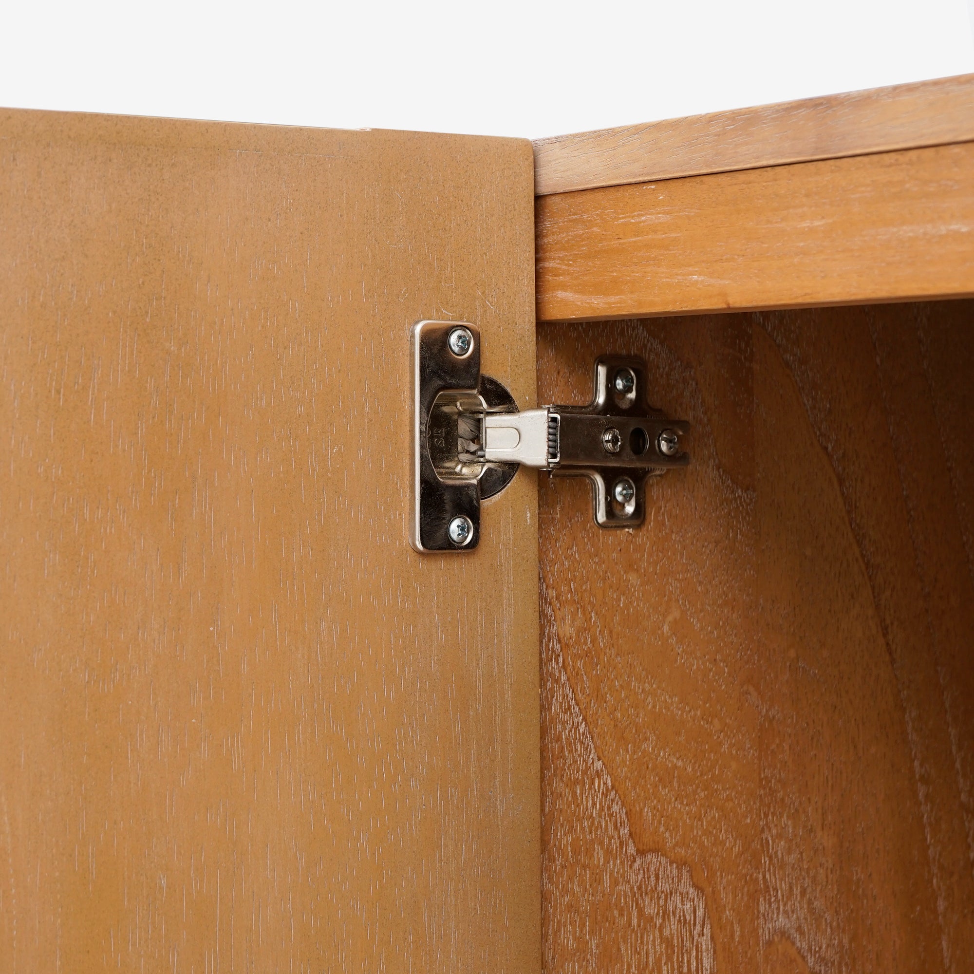 Close-up of a wooden cabinet with a hinge
