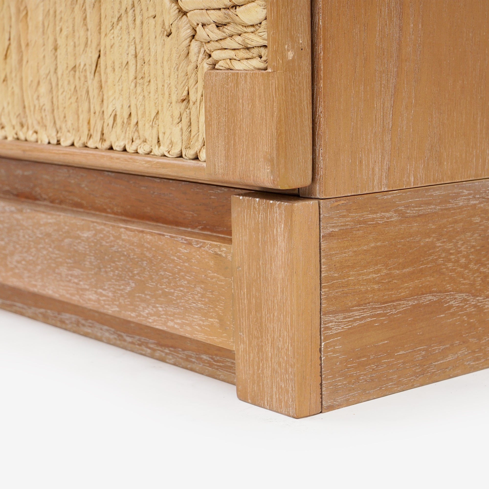 Close-up of a wooden furniture corner with woven detailing 
