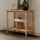 Wooden console table with decorative items against a neutral wall.