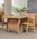 Wooden dining table with chairs in a room with a painting on the wall.