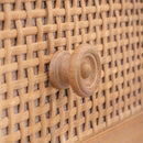Close-up of a woven rattan wall with a wooden knob