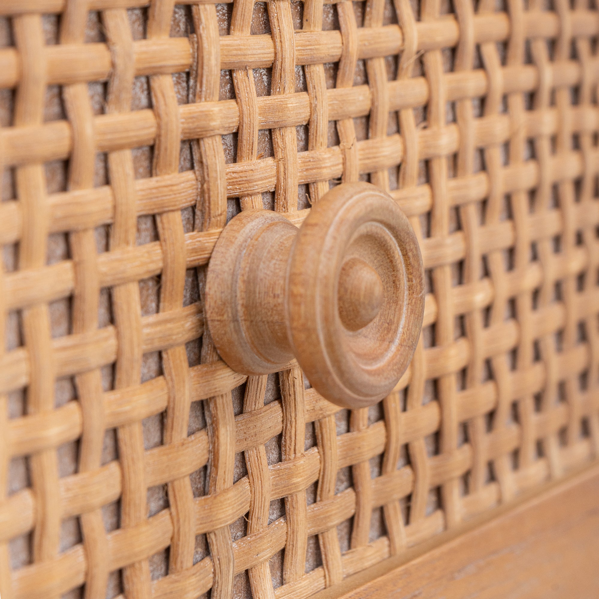 Close-up of a woven rattan wall with a wooden knob