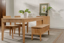 Wooden dining set with table, chairs, and bench in a room with a plant and framed picture.